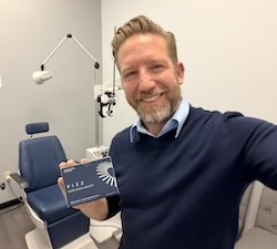 Doctor holding VIZZ eyedrops package.